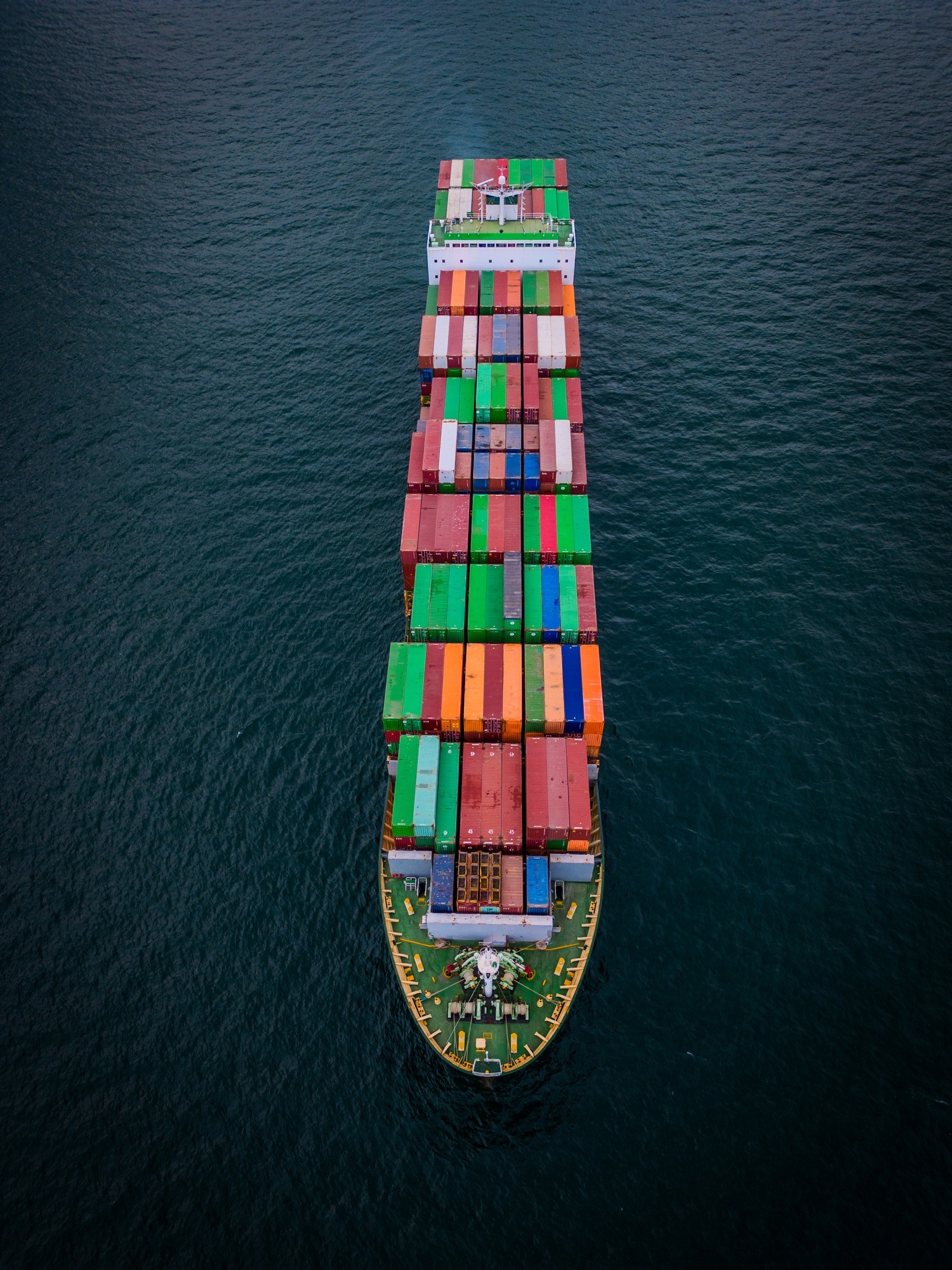 A loaded container ship in the sea, aerial view, concept of international trade and shipping