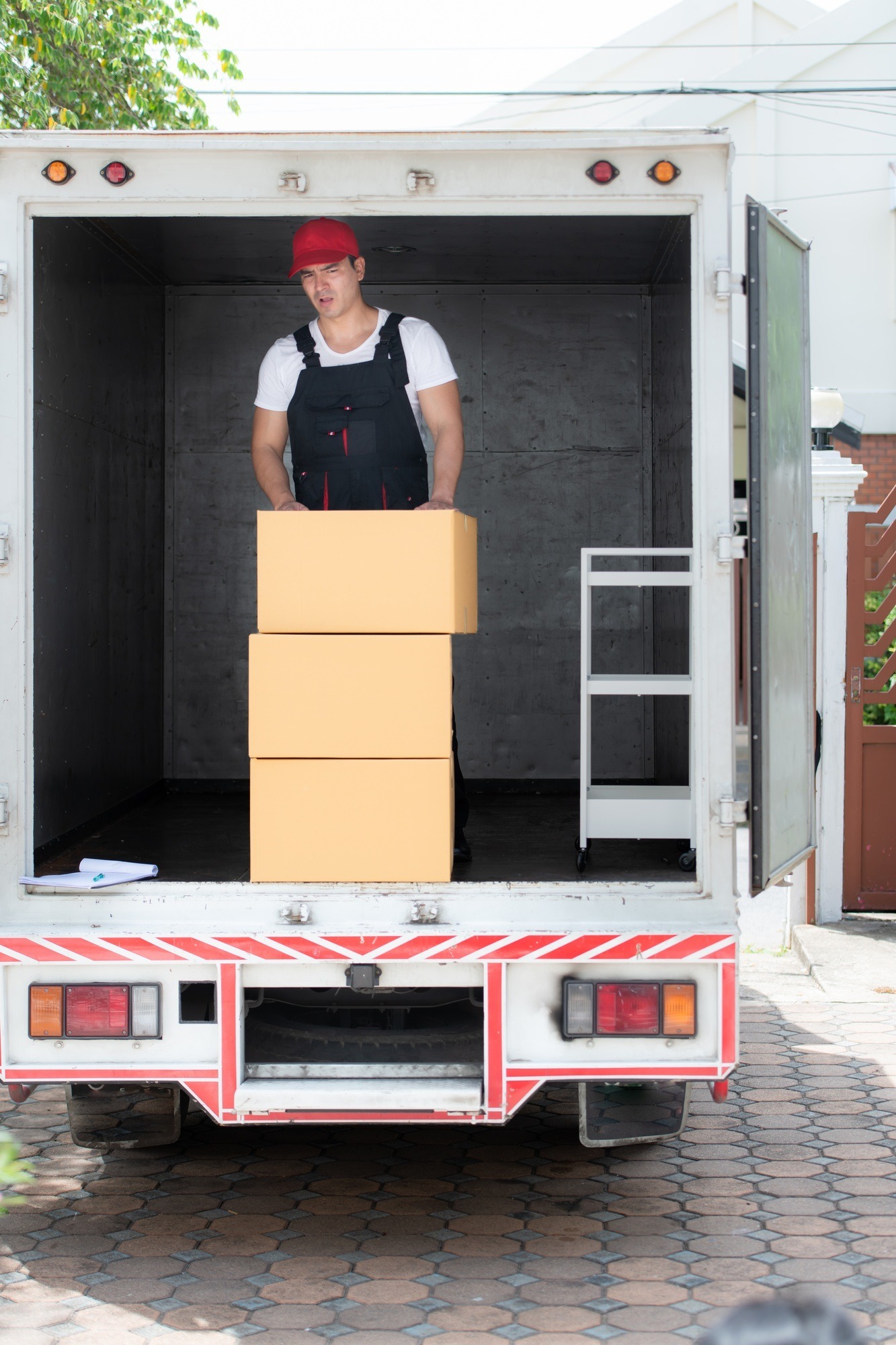 Delivery man with boxes door to door moving services
