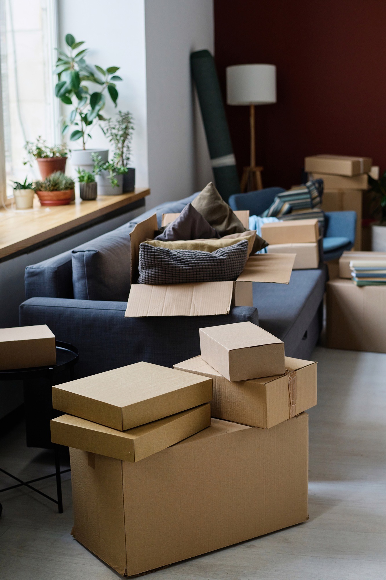 Trained furniture movers in London loading sofa into van