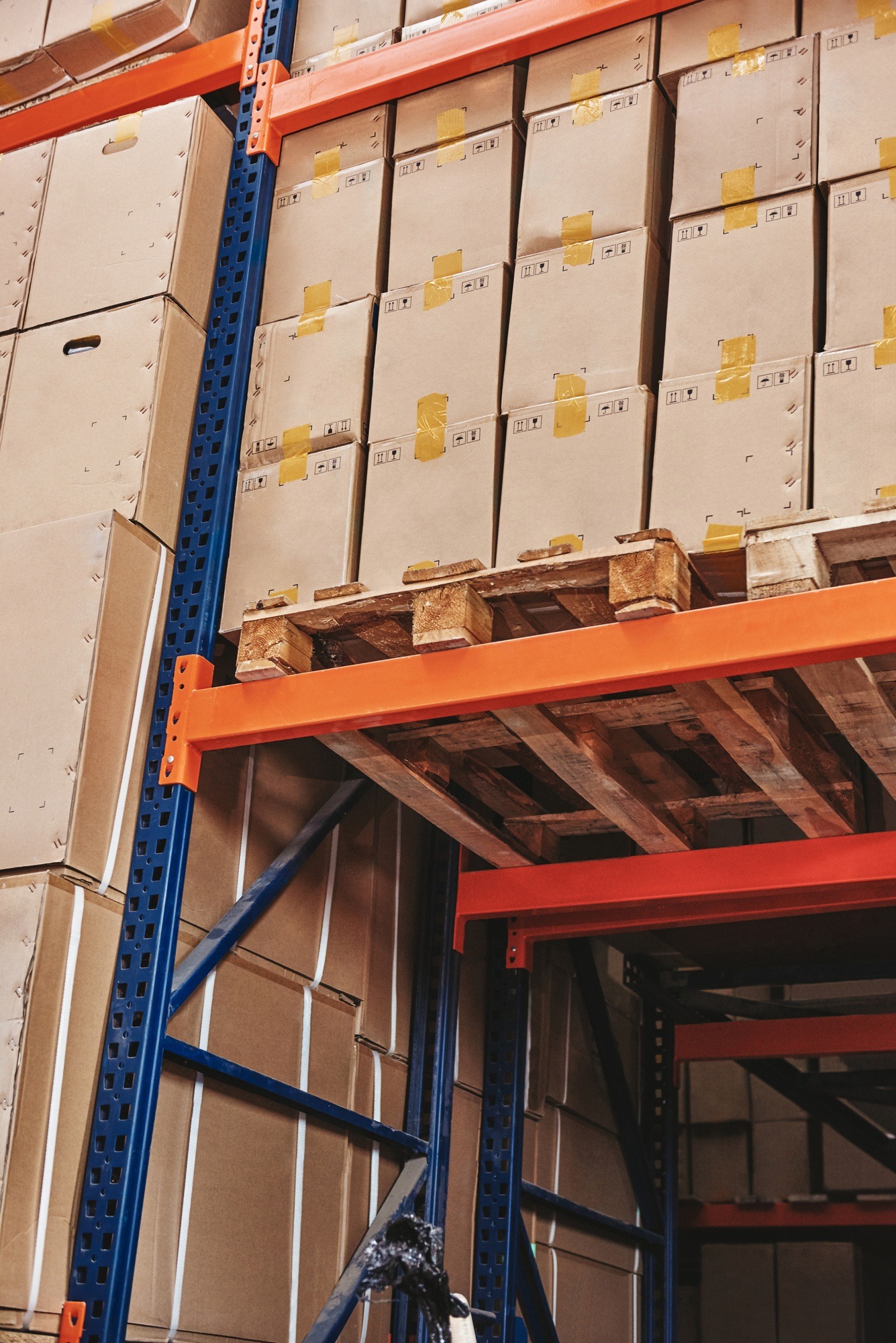 groupage service Stack of cardboard boxes on wooden pallet in distribution warehouse