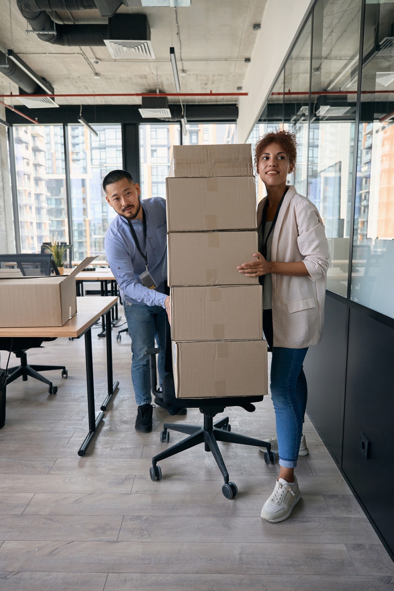 Two young company employees conducting office move